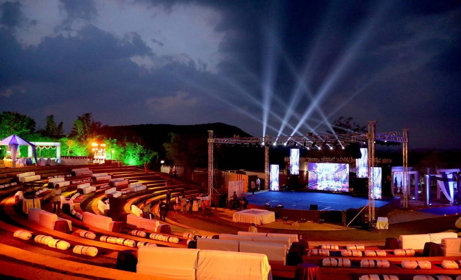 Stage with LED screens and light beams at night